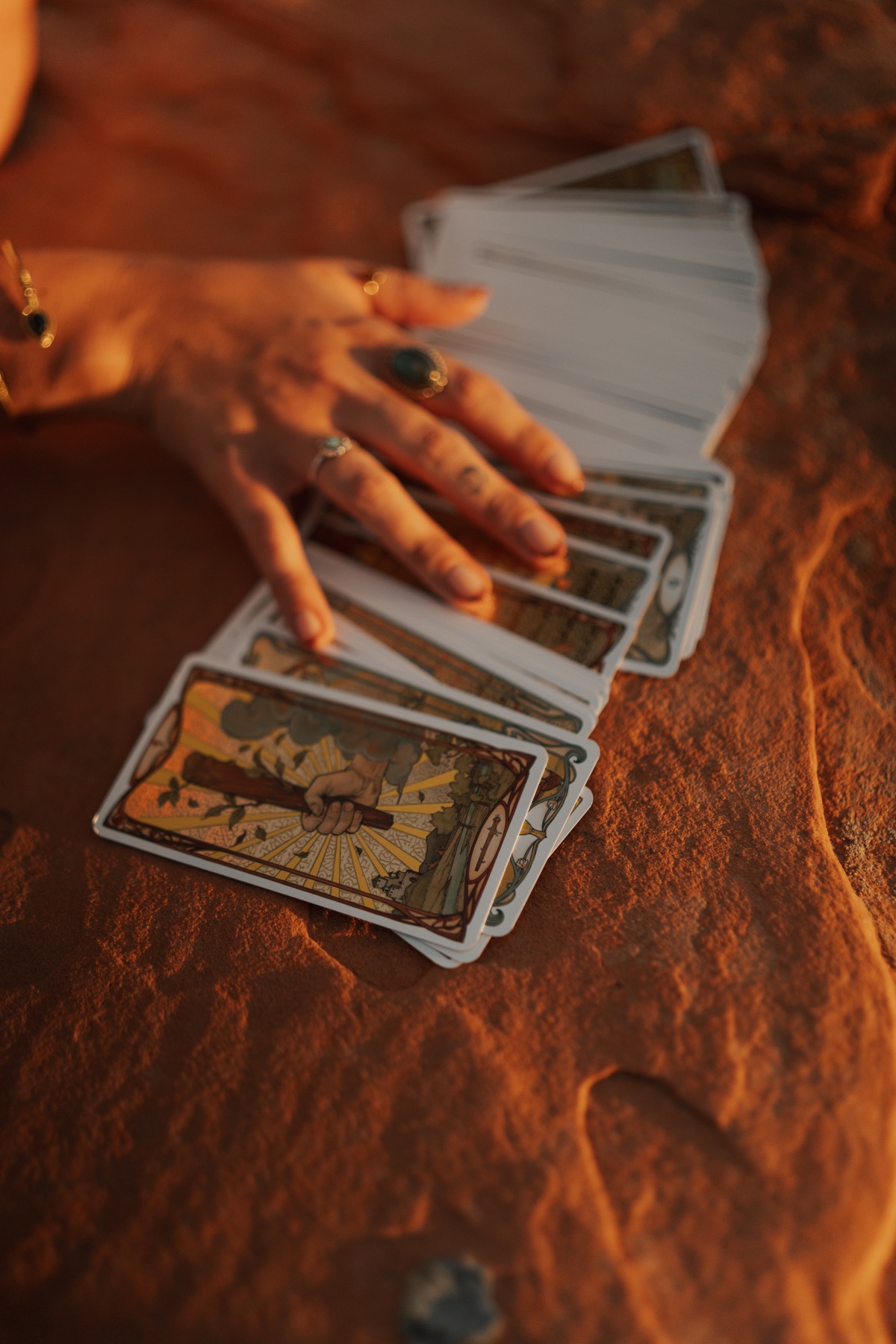 Tarot cards spread across warm desert sandstone
